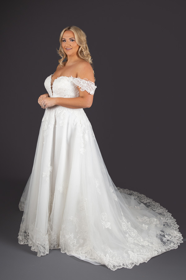 Model standing looking directly ahead wearing Alice Bridal Dress stocked by Roberta's Bridal, Burslem