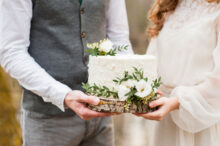 Bride and groom holding wedding cake