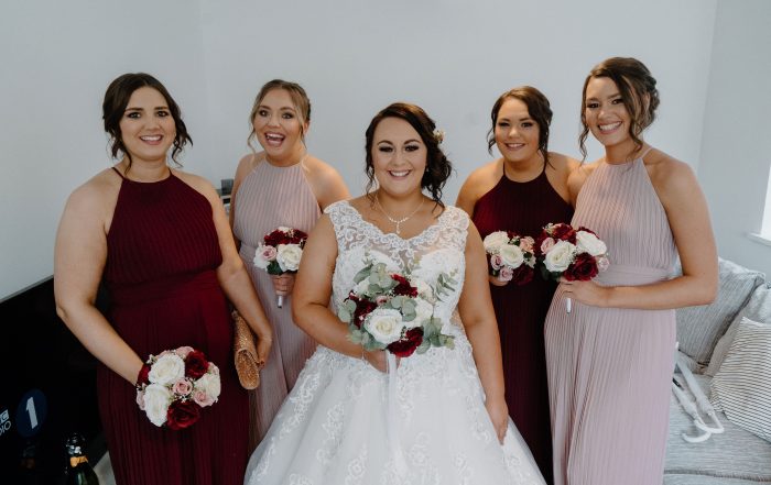 Bride Kelsey Ellerton with her bridesmaids in their dresses from Roberta's Bridal