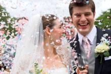 Bride and groom under a shower of confetti